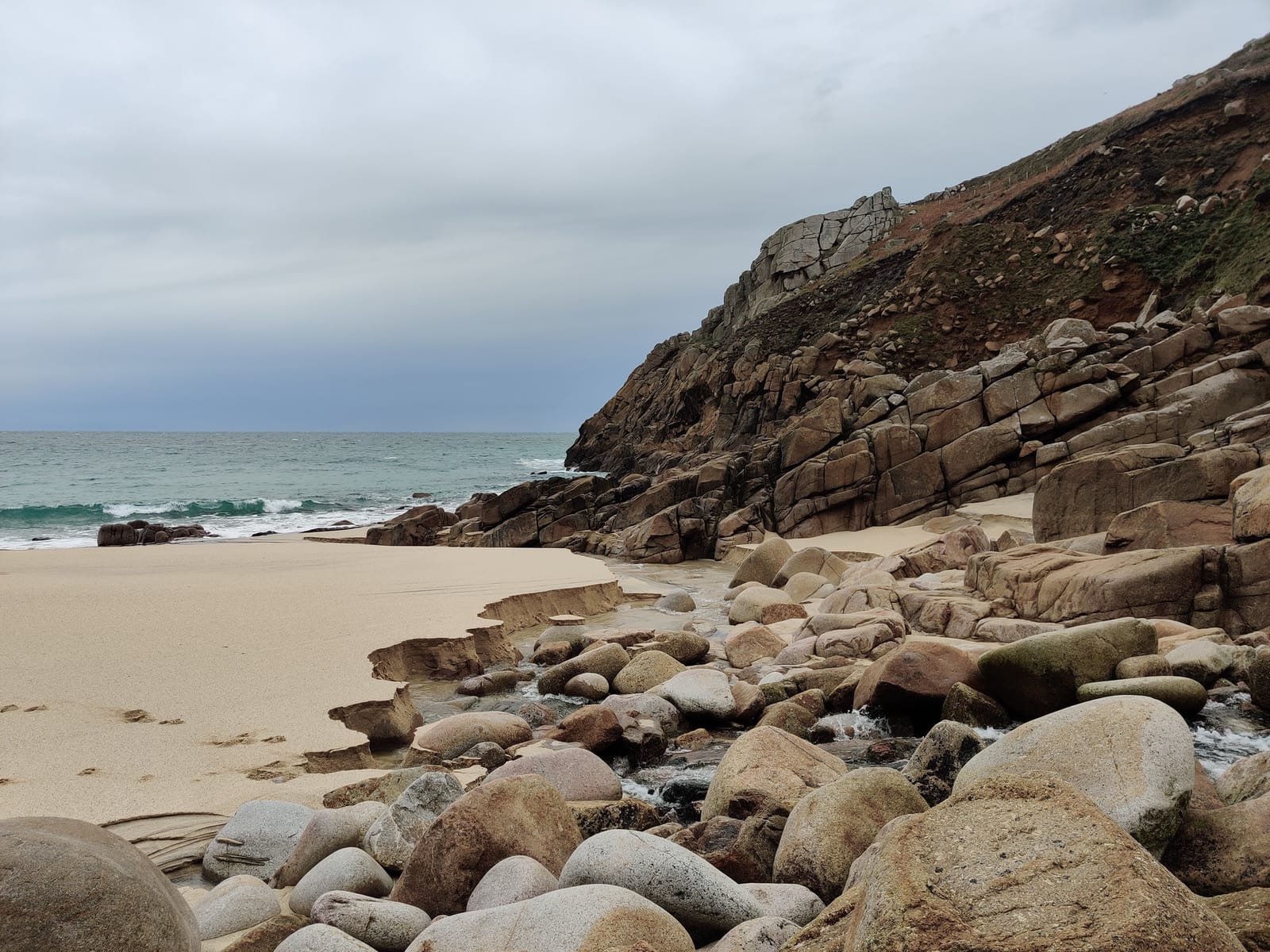 A quiet Cornish cove: sand, granite boulders and the sea